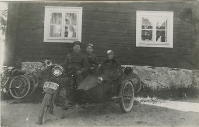 Tre personer på motorcykel med sidovagn