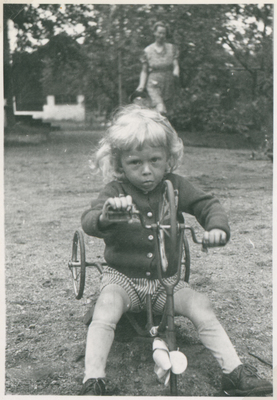 Flicka leker med trehjuling år 1946