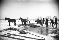 Män med hästar hämtar isblock för att lägga i isdös